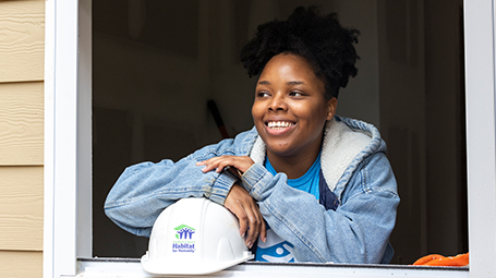 Habitat team member looking out a window