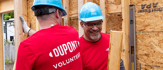 Corporate volunteer working on a Habitat home construction project