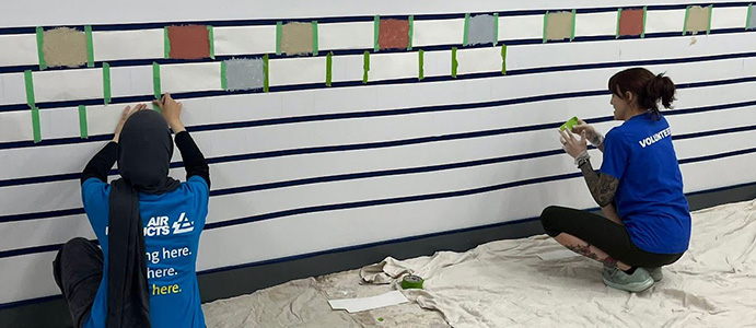 Volunteers painting a wall